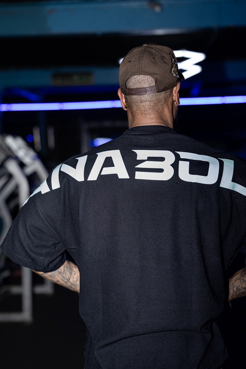 Model wearing Anabolic Apparel gym shorts in a studio